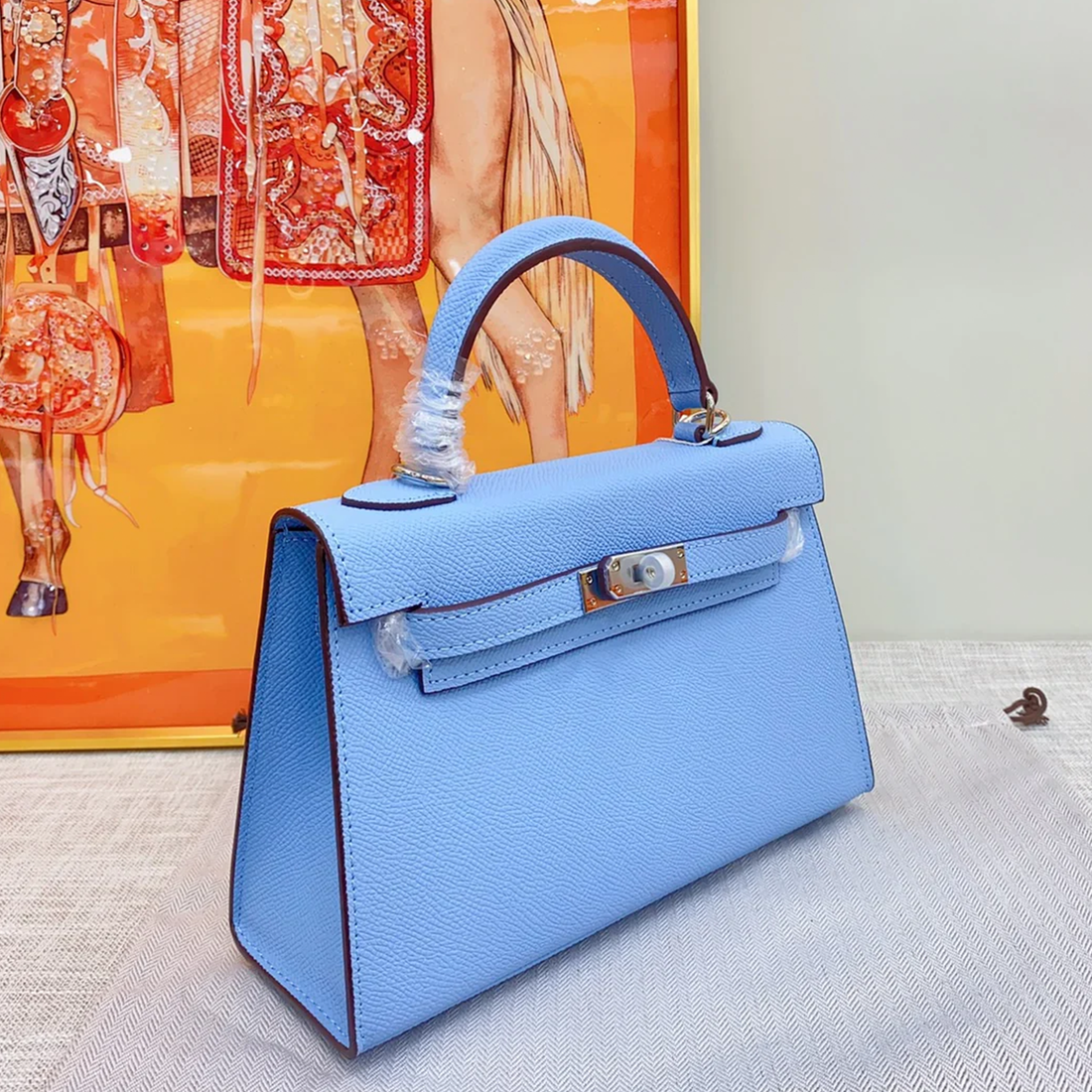 Airy Sky Blue Fine Grain Slim Compact Rectangular Hand Carry Bag With Sleek Silvery Twist Lock Hardware And Thin Dark Contrast Edge Piping